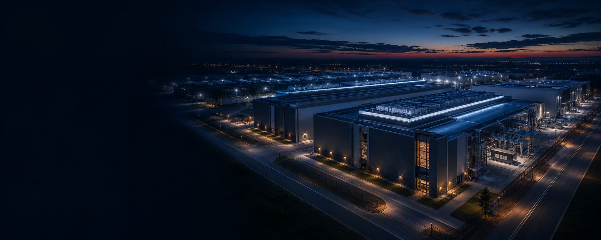 Data-center campus at blue hour with electrical and cooling infrastructure